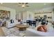 An open concept living room features modern furniture, sleek decor and light colored walls at 722 Ocmulgee Xing, Locust Grove, GA 30248