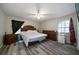 This bedroom features wood floors, a large bed, and side tables at 5070 Maryland Nw Dr, Acworth, GA 30101