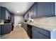 Eat-in kitchen with stylish blue cabinets, white backsplash, and stainless steel appliances at 5070 Maryland Nw Dr, Acworth, GA 30101
