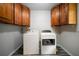 Convenient laundry room with washer, dryer, and upper cabinets at 5070 Maryland Nw Dr, Acworth, GA 30101