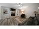 Bright living room with a fireplace, built-in shelves, and modern flooring at 5070 Maryland Nw Dr, Acworth, GA 30101
