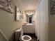Bright bathroom featuring a vanity with ample lighting and an open toilet area at 2275 Chestnut Log Loop, Lithia Springs, GA 30122