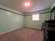 Cozy bedroom featuring soft carpet, light green walls, and a bright window for natural light at 2275 Chestnut Log Loop, Lithia Springs, GA 30122