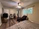 Comfortable bedroom featuring hardwood floors, a ceiling fan, and ample natural light at 2275 Chestnut Log Loop, Lithia Springs, GA 30122