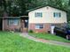 Charming split-level home featuring a brick facade and a well-maintained front yard with mature trees at 2275 Chestnut Log Loop, Lithia Springs, GA 30122
