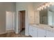 Bathroom highlighting double vanity, mirror, lights, walk-in closet, and shower at 70 Trinity Lane, Covington, GA 30016