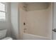 Bathroom features a tub with shower, window and toilet at 70 Trinity Lane, Covington, GA 30016