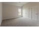 Bedroom features plush carpeting, neutral walls, window and closet at 70 Trinity Lane, Covington, GA 30016