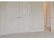 Bedroom features plush carpet, neutral walls, and spacious closet at 70 Trinity Lane, Covington, GA 30016