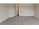 Bedroom with neutral walls, plush carpet and open doorway to hall at 70 Trinity Lane, Covington, GA 30016