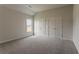 Bedroom features plush carpeting, neutral walls, window and closet at 70 Trinity Lane, Covington, GA 30016