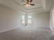 Spacious bedroom with tray ceiling, large windows, and cozy carpet flooring at 70 Trinity Lane, Covington, GA 30016