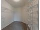 Walk-in closet includes metal shelving and neutral carpeting at 70 Trinity Lane, Covington, GA 30016