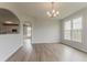 Dining room with chandelier and arched doorway to kitchen at 70 Trinity Lane, Covington, GA 30016