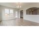 Bright dining room with wood floor, chandelier, large windows, and adjacent rooms at 70 Trinity Lane, Covington, GA 30016