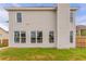 Large fenced-in backyard with lush green grass and a light exterior at 70 Trinity Lane, Covington, GA 30016