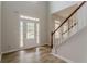 Bright, open foyer features a staircase with wood railings and an exterior door at 70 Trinity Lane, Covington, GA 30016
