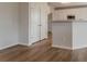 Bright kitchen featuring white cabinetry, a center island, hardwood floors, and modern fixtures at 70 Trinity Lane, Covington, GA 30016