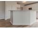 Kitchen island featuring white cabinets and flooring, perfect for meal preparation and storage at 70 Trinity Lane, Covington, GA 30016