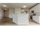 Bright kitchen featuring white cabinets, a center island, hardwood floors, and modern fixtures at 70 Trinity Lane, Covington, GA 30016