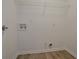 Functional laundry room includes hookups, wire shelf, and plank flooring at 70 Trinity Lane, Covington, GA 30016