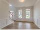 Bright living room with large windows, wall trim and wood-style flooring at 70 Trinity Lane, Covington, GA 30016