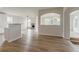 Open-concept living room with hardwood floors, arched doorways, and plenty of natural light, adjacent to the kitchen at 70 Trinity Lane, Covington, GA 30016