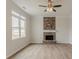 Living room with a stone fireplace and a ceiling fan at 70 Trinity Lane, Covington, GA 30016