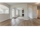 Spacious open-concept living room featuring hardwood floors, arched doorways, and abundant natural light at 70 Trinity Lane, Covington, GA 30016