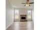 Living room with a stone fireplace and a ceiling fan at 70 Trinity Lane, Covington, GA 30016