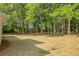 Large, private backyard with mature trees, offering ample space for outdoor activities and relaxation at 1834 Stroud Road, Mcdonough, GA 30252