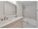 A lovely bathroom features double sinks, a stylish shower, and a gold framed mirror at 1834 Stroud Road, Mcdonough, GA 30252