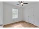 Bedroom featuring ceiling fan, large window and a white door at 1834 Stroud Road, Mcdonough, GA 30252