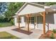 Charming home front porch with wooden supports, white siding, and updated landscaping at 1834 Stroud Road, Mcdonough, GA 30252