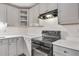 Close-up of kitchen showcasing stove, sleek countertops, and cabinetry at 1834 Stroud Road, Mcdonough, GA 30252