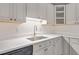 Kitchen corner featuring a stainless steel sink, white countertops and cabinets at 1834 Stroud Road, Mcdonough, GA 30252