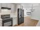 Bright, open kitchen with black appliances and view of dining area with fireplace at 1834 Stroud Road, Mcdonough, GA 30252
