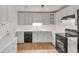 Bright kitchen featuring white cabinets, modern countertops, and stainless steel appliances at 1834 Stroud Road, Mcdonough, GA 30252
