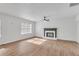 Open living area featuring updated flooring, neutral walls, a ceiling fan, and a cozy fireplace at 1834 Stroud Road, Mcdonough, GA 30252