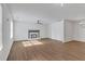 Bright living room with luxury vinyl flooring, white walls, a traditional fireplace, and a ceiling fan at 1834 Stroud Road, Mcdonough, GA 30252