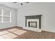 Bright living room with luxury vinyl flooring, white walls, and a white-brick fireplace with a decorative mantle at 1834 Stroud Road, Mcdonough, GA 30252