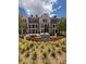 Exterior view of townhomes with manicured landscaping, colorful flowers, and community gathering spaces at 2197 Wexford Dr # 39, Atlanta, GA 30319