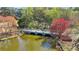 Scenic view of a pond with a stone bridge surrounded by lush trees and colorful foliage at 2197 Wexford Dr # 39, Atlanta, GA 30319