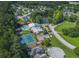 Community aerial view showcasing lush trees, a pool, and tennis courts near homes at 301 Retreat Way, Carrollton, GA 30116