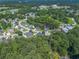 Community aerial view showcasing lush trees surrounding established homes at 301 Retreat Way, Carrollton, GA 30116