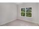 Bright bedroom with a large window offering a private wooded view at 301 Retreat Way, Carrollton, GA 30116