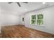 Bright bedroom with beautiful hardwood flooring and a window at 301 Retreat Way, Carrollton, GA 30116