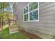 Home exterior featuring gray siding with an entrance to the backyard at 301 Retreat Way, Carrollton, GA 30116