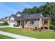 Beautifully landscaped house with an attached two-car garage and a cozy side porch overlooking the lake at 301 Retreat Way, Carrollton, GA 30116