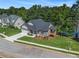 Beautifully landscaped house with an attached two-car garage and a cozy side porch overlooking the lake at 301 Retreat Way, Carrollton, GA 30116